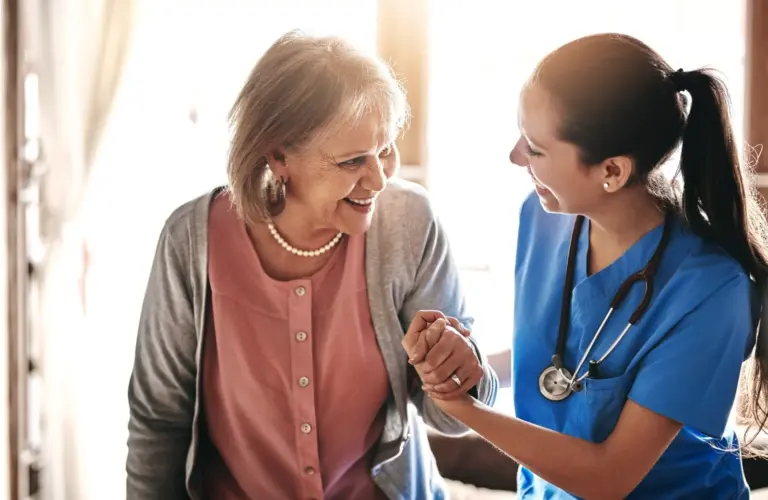 A nurse talking with an older woman.